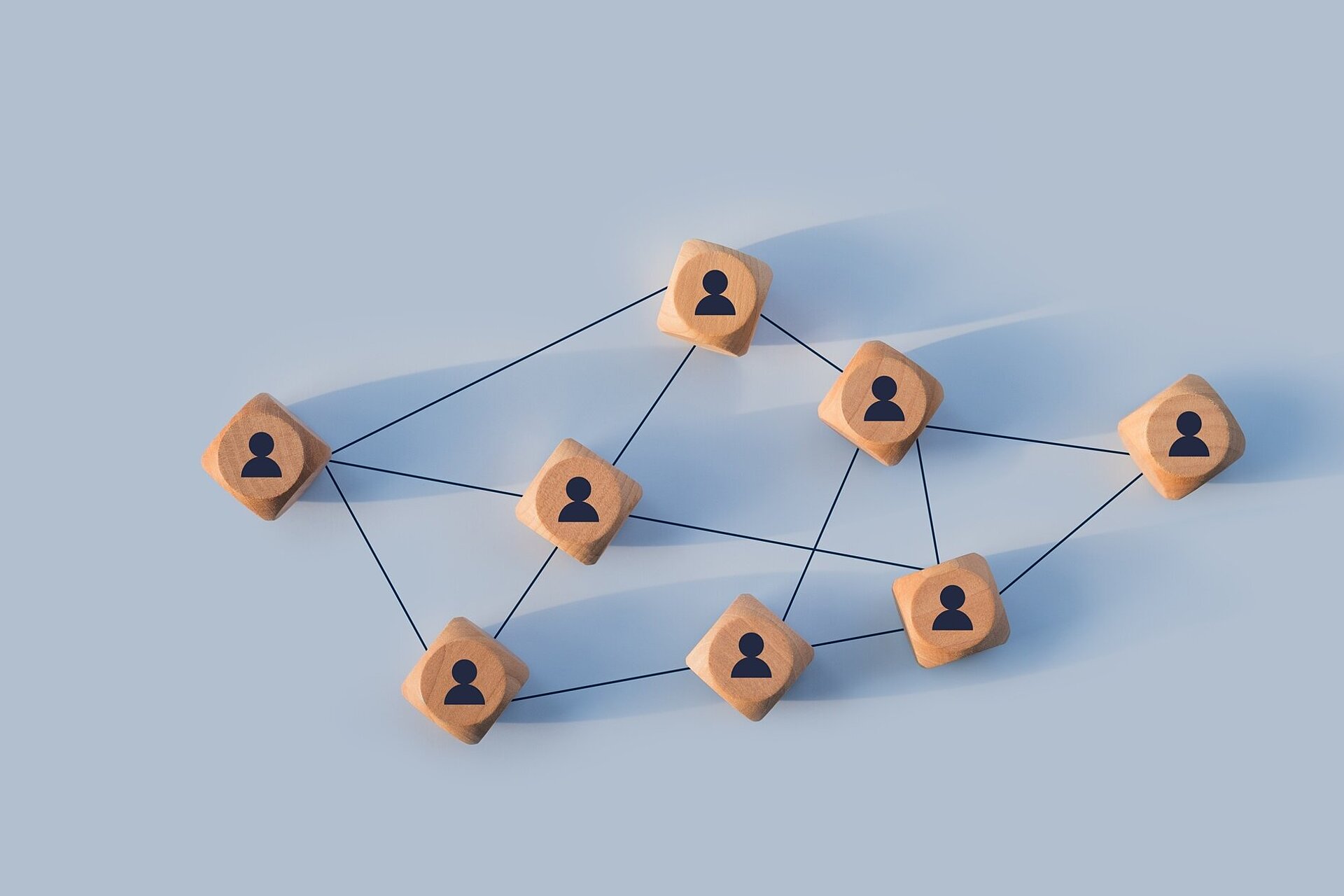 Organizational,Network,Structure,With,Connected,People,Icons,On,Wooden,Blocks,