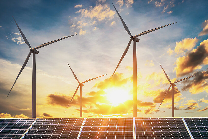 Wind,Turbine,With,Solar,Panels,And,Sunset.,Concept,Clean,Energy